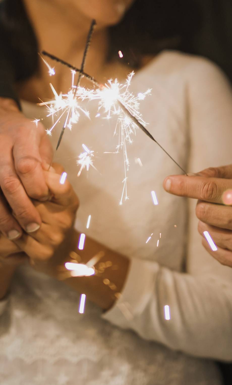 close-up-shot-senior-couple-holding-fireworks